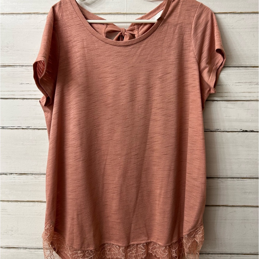 Very comfortable Lauren Conrad blouse. Lace on bottom and silk bow on back.